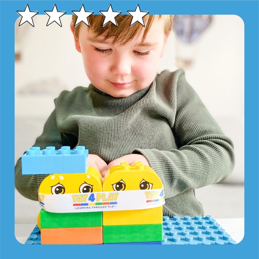A kid aged around 3-4 years old playing with our building blocks and emotion bricks