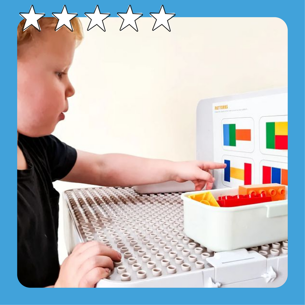 Kid aged around 3 years old playing with our building blocks and patterning sheets